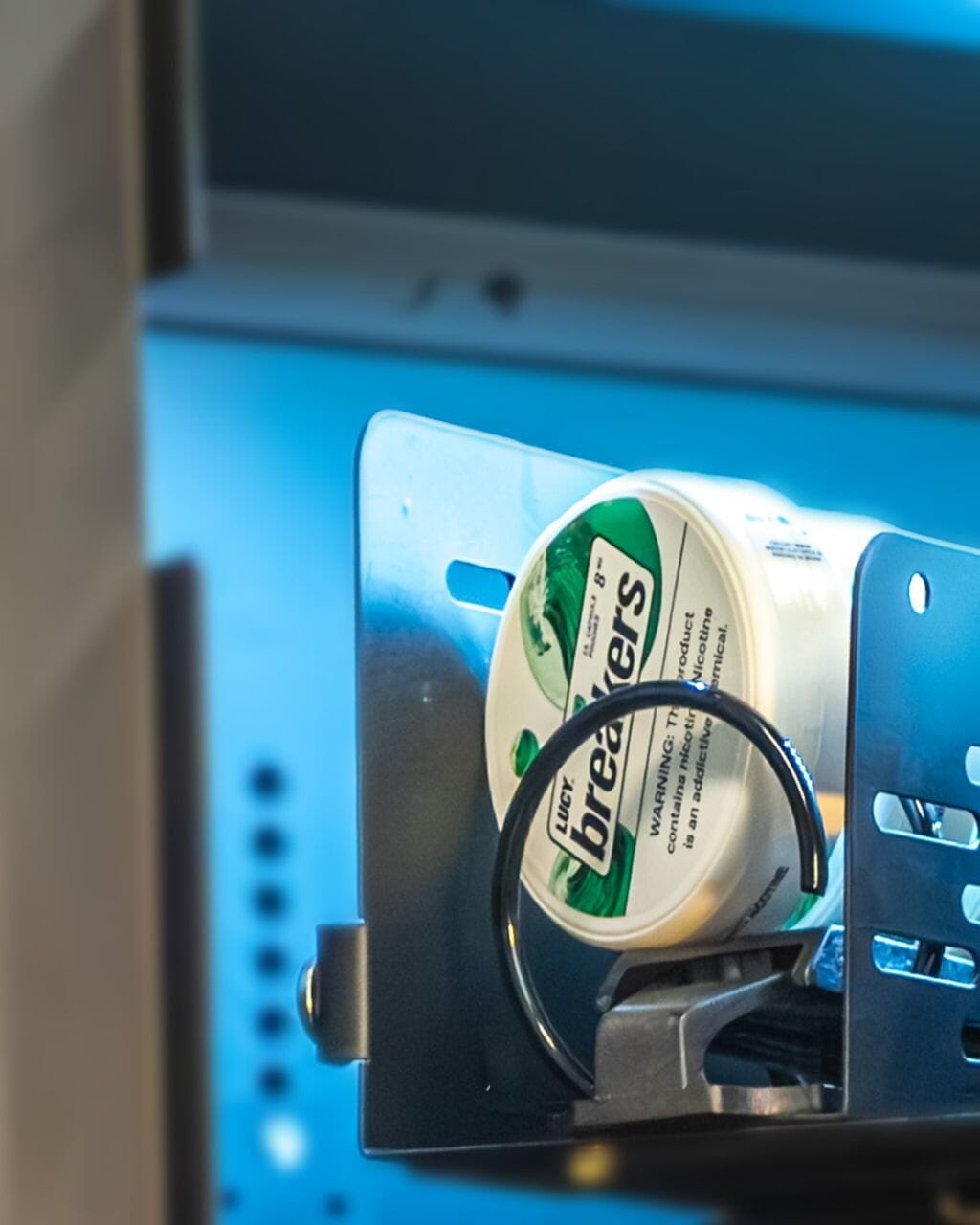 zyn tin lifter adapter holding a nicotine pouch in a vending machine