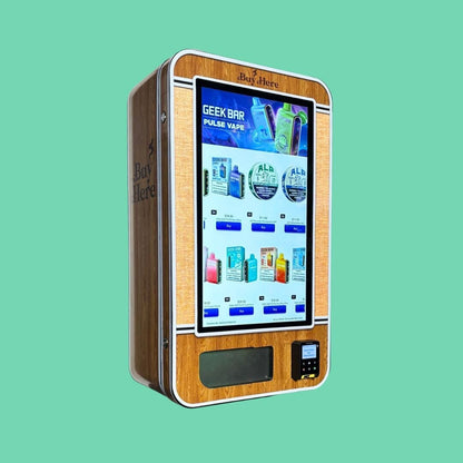 Wood-grain slim wall vape vending machine with ‘Buy Here’ branding, touchscreen menu showing Geek Bar vapes and ALP nicotine pouches, and integrated payment reader.