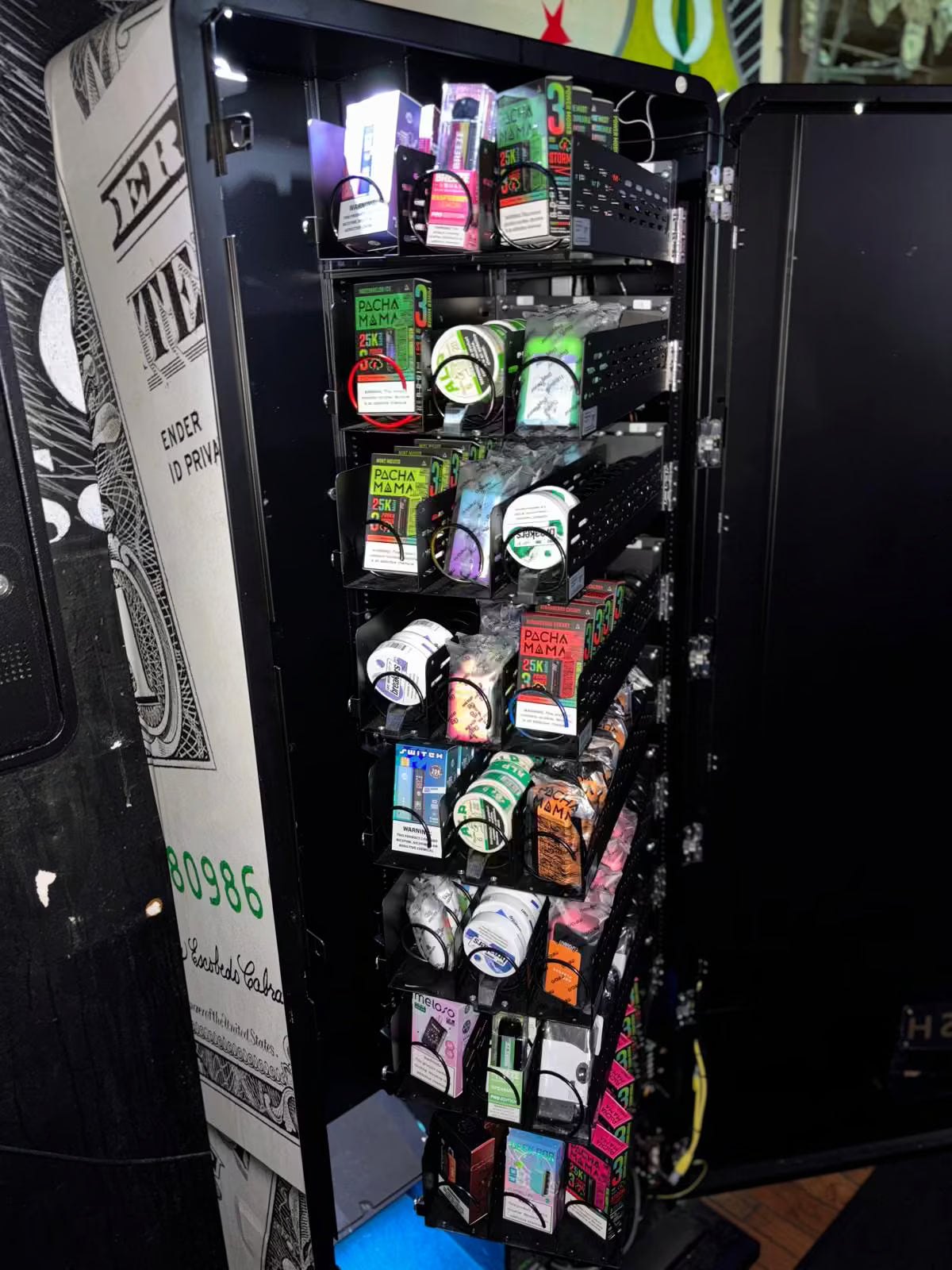 VapeTM touchscreen vape vending kiosk interior with 24 aisles stocked with vape and and nicotine products