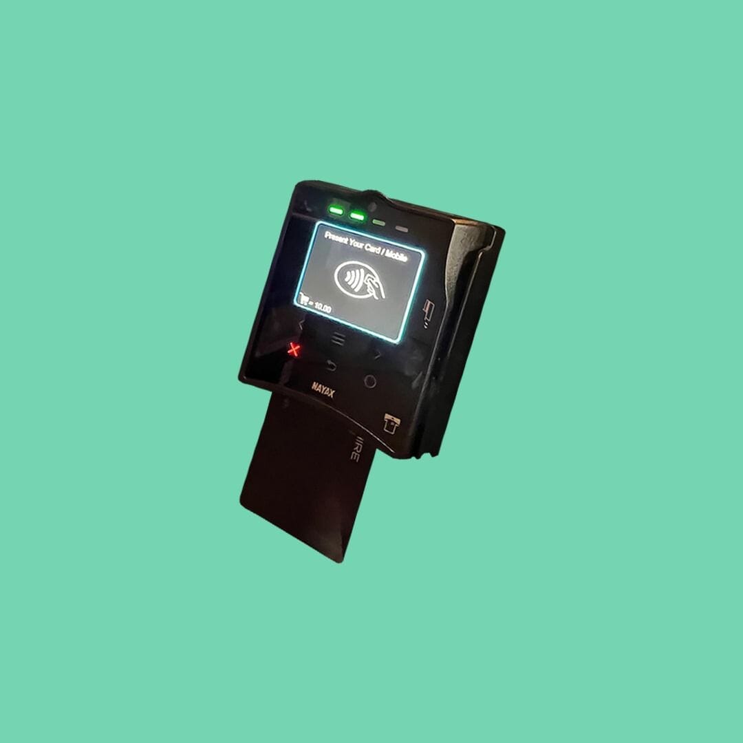 NAYAX VPOS Touch device powered on with contactless symbol visible.