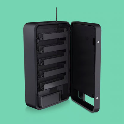 Interior view of the Pokemon Slim Wall TCG vending machine with open door showing 5 empty coil shelves and full aisle configuration ready for restocking booster packs