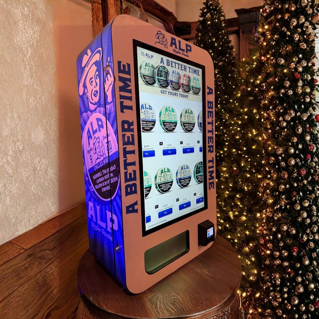 Custom-wrapped free-standing or wall-mounted vending machine featuring an ALP nicotine pouch design displayed at a Tucker Carlson Christmas event.
